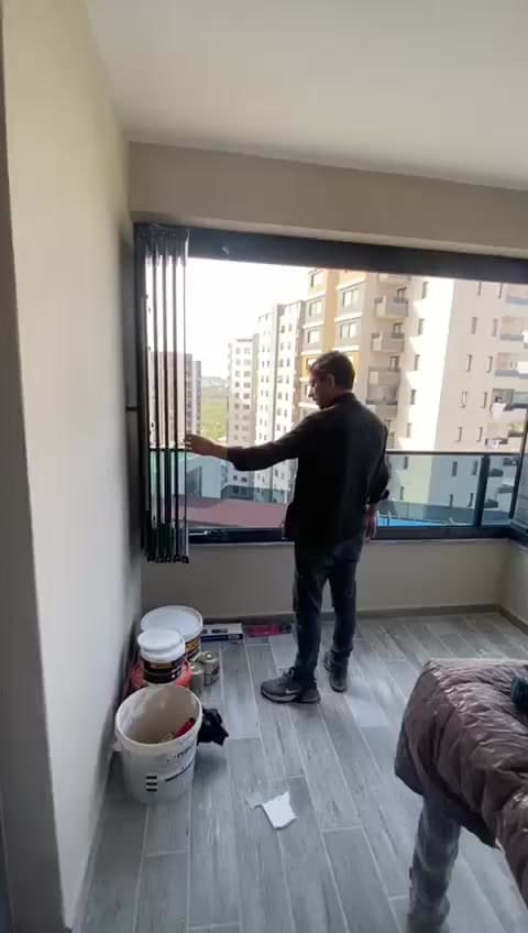 Balkonda cam panel üzerinde çalışan uygulama ekibi