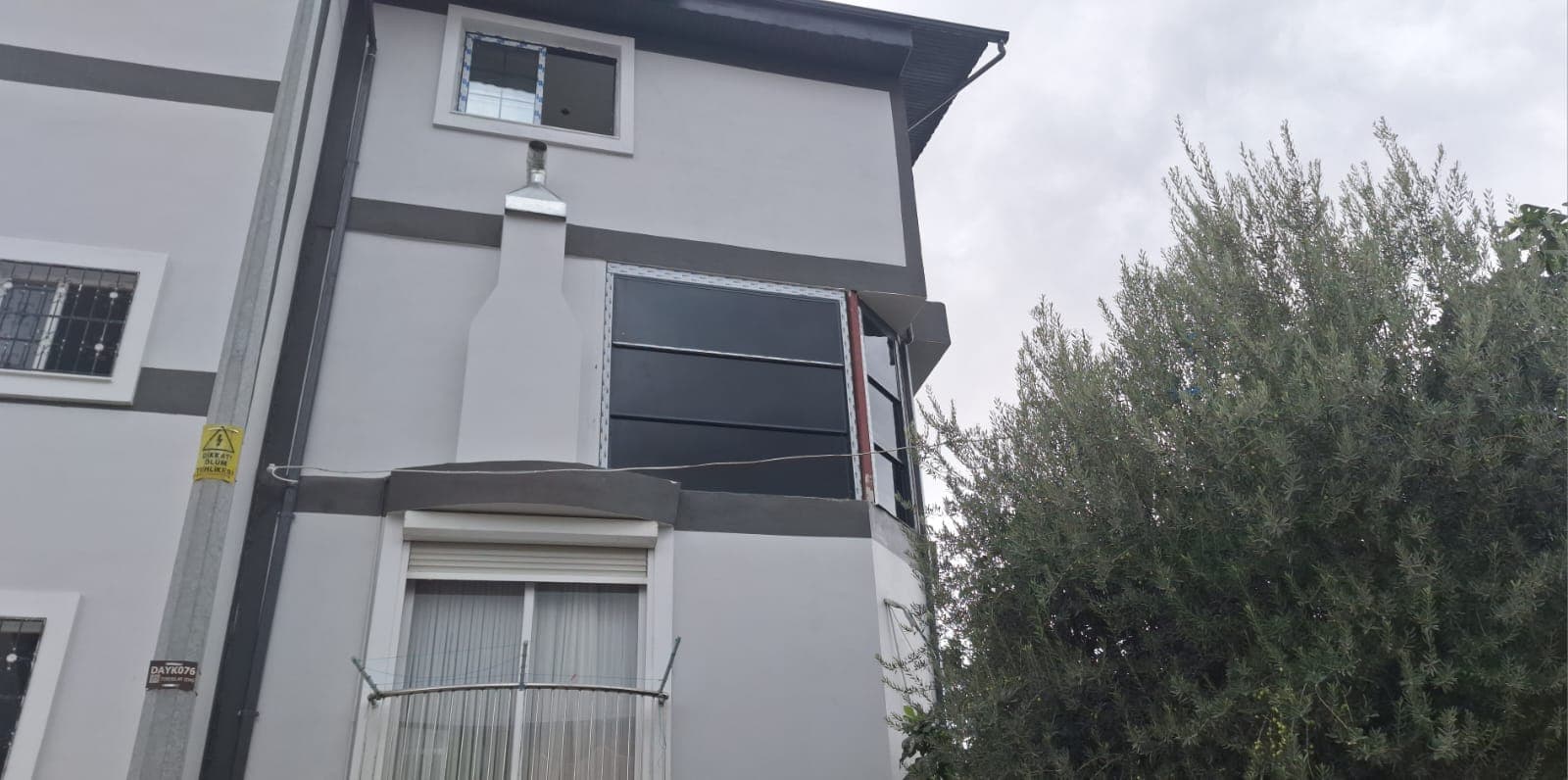 Konut cephesinin önündeki cam sistemin dışarıdan görünümü