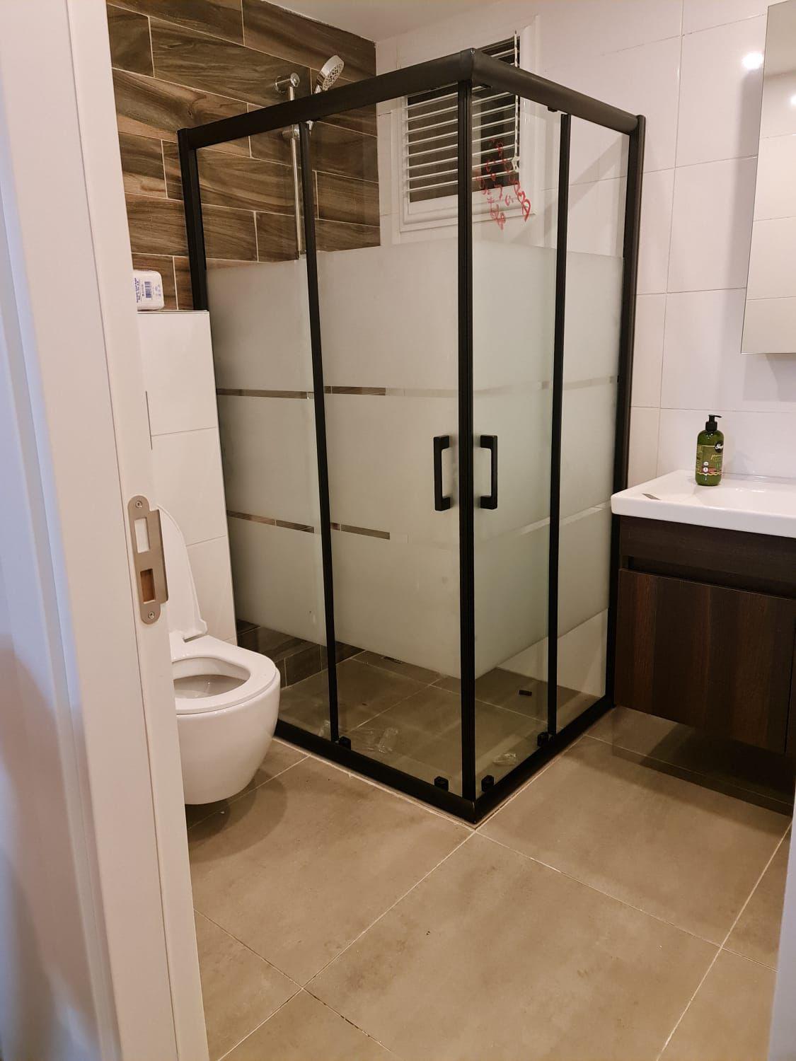 Siyah çerçeveli köşe duşakabin ve banyo dolabı
